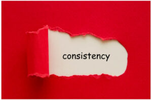 The word consistency shown through torn red paper, representing steady activity in the headache boom bust cycle.