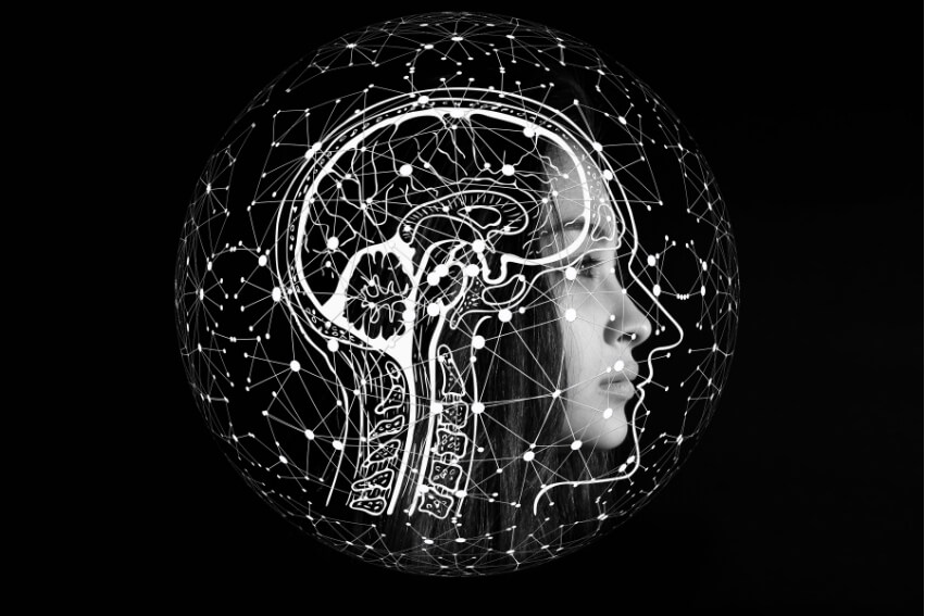 Black-and-white profile of a person with a brain and connected network graphic representing migraine sensory overload.