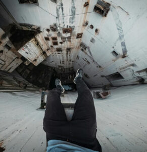 Person experiencing dizziness and imbalance at height, representing vestibular migraine brain health challenges