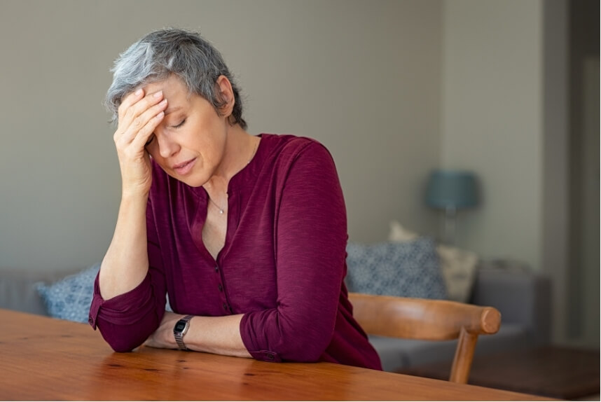 Woman experiencing headaches and migraines linked to stress and uncertainty
